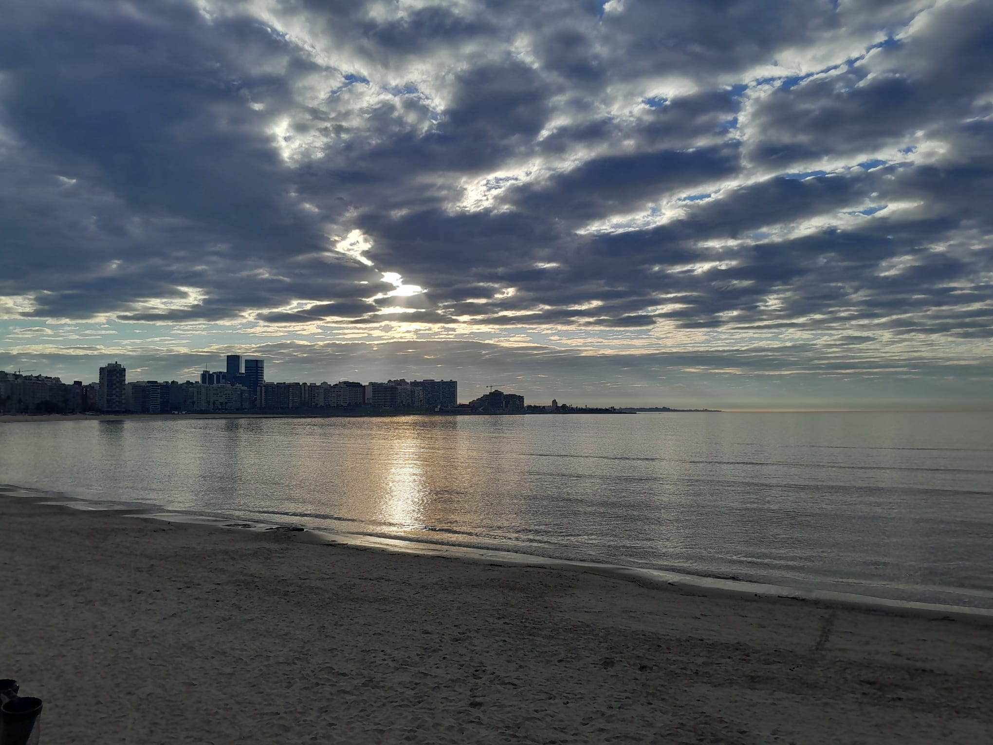 Pocitos bay and its towers, sun breaking through clouds over the river.